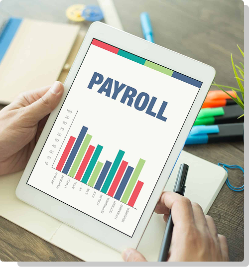 Hand holding a wooden block that reads payroll