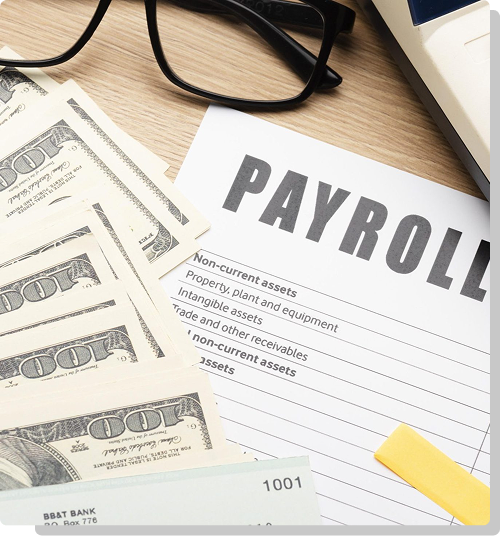 Hand holding a wooden block that reads payroll